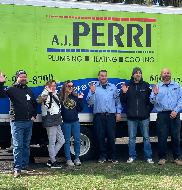A.J. Perri HVAC technicians and plumbers in Brick, NJ, in front of their company van.
